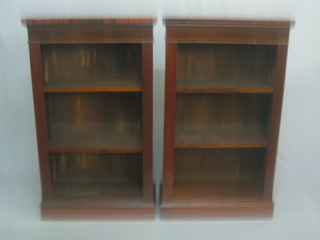 A pair of mahogany bookcases fitted adjustable shelves 25"