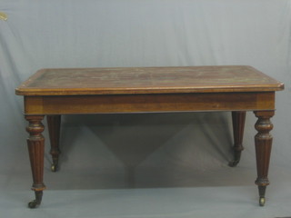 A Victorian mahogany library table fitted a frieze drawer and raised on turned supports 61"