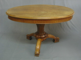 A Victorian oval oak Loo/Estate table raised on pillar and tripod supports 48"