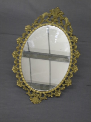 An oval plate mirror contained in a pierced decorative frame 13"