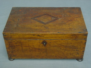 A 19th Century rectangular oak trinket box with hinged lid raised on bun feet 12"