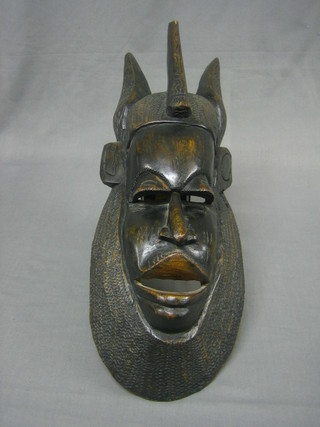 A carved Eastern wall mask 22"
