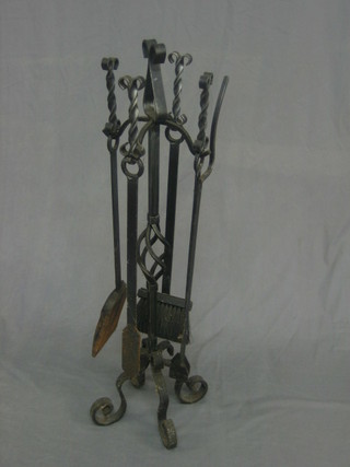 A wrought iron 4 piece fireside companion set