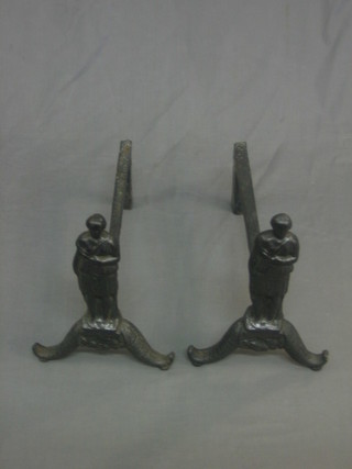 A pair of Victorian wrought iron fire dogs in the form of standing classical figures