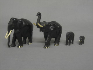 A troop of 9 various ebony elephants with ivory tusks