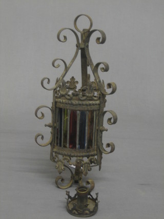 A cylindrical  wrought iron lantern 