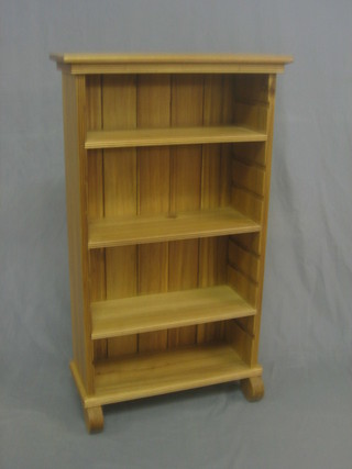 A Victorian style bleached mahogany bookcase fitted adjustable shelves raised on scrolled feet 22"