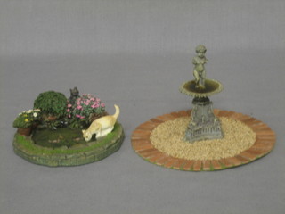 A circular dolls house fountain together with a pond
