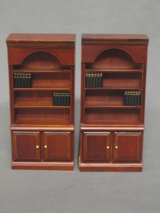 A pair of dolls house mahogany bookcases fitted shelves with cupboards beneath complete with some books 3"