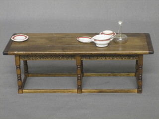 A dolls house oak refectory style dining table raised on turned supports