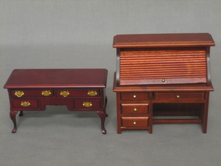 A dolls house mahogany finished dresser base fitted 2 long drawers above 2 short drawers together with a mahogany roll top desk