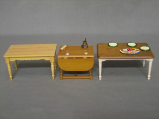 A dolls house rectangular pine kitchen table, 1 other kitchen table and a drop flap table
