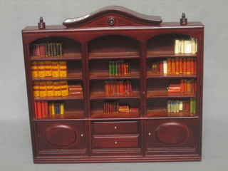 A dolls house mahogany finished library bookcase fitted various books etc 9"