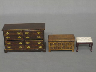 A dolls house oak chest of 8 long drawers 4 1/2", an oak coffer 3" and a mahogany stool 1"