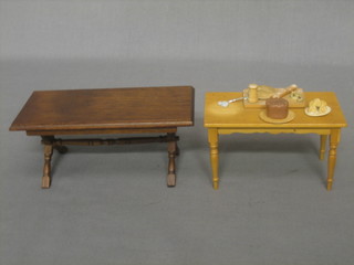 A dolls house rectangular pine kitchen table, a pork pie and other pies and a rectangular refectory style dining table