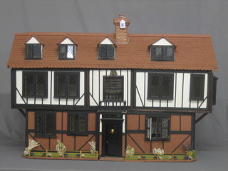 A dolls house in the form of a Tudor half timbered cottage 44"