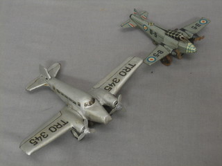 A clockwork model passenger aircraft together with a tin plate clockwork model aircraft