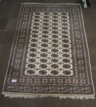 A cream and brown ground Bokhara carpet  with 56 octagons to the centre 115" x 74"