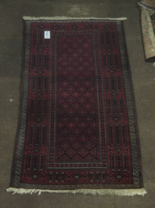 A Belouch red ground rug 71" x 27"