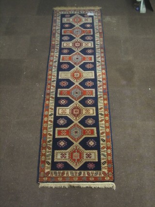 A blue ground Persian runner with stylised octagons to the centre 116" x 32"