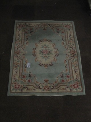 A Chinese green ground and floral patterned rug 70" x 47"