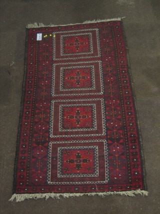A red ground Belouch rug 78" x 41"
