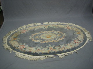 An oval blue ground and floral patterned Chinese rug 62"