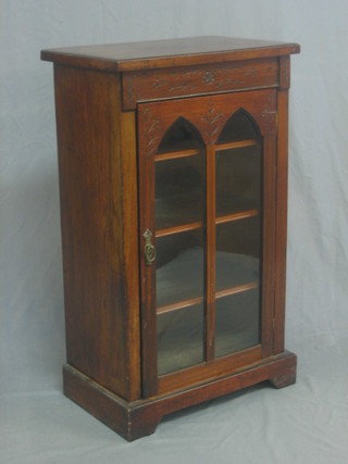 A Victorian carved walnut music cabinet the interior fitted shelves enclosed by arch shaped panelled doors 21"