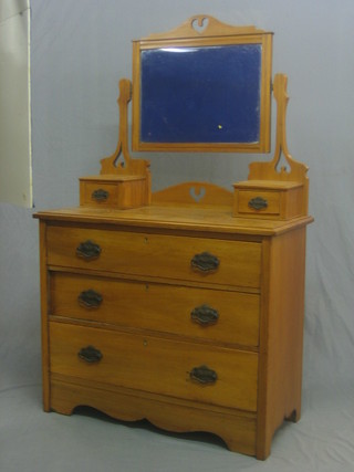 A Victorian satinwood dressing table with rectangular bevelled plate mirror, the base fitted 2 glove drawers above 3 long graduated drawers 36"