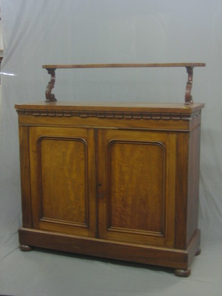 A William IV mahogany chiffonier with raised shelf back the base fitted a cupboard enclosed by arch panelled doors, raised on bun feet 44"