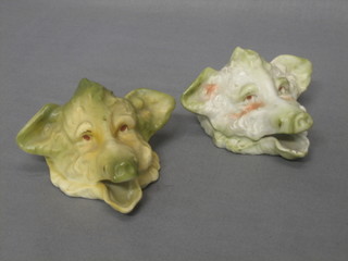 A pair of Continental porcelain wall pockets in the form of wild boars masks 4 1/2" 