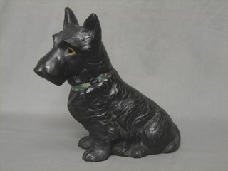 A black glazed figure of a seated Scottie Dog, base marked RD778504 Made in England 10"