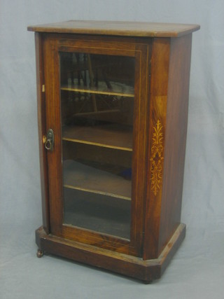 An Edwardian inlaid walnut music cabinet fitted shelves enclosed by a glazed panelled door 21"