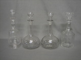 A pair of Victorian cut glass club shaped decanters and 2 other decanters