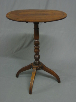 A Georgian oval inlaid mahogany snap top wine table, raised on pillar and column supports (crack to centre)