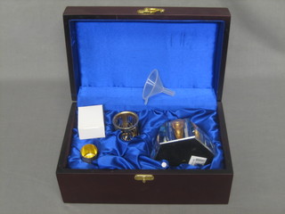 A faceted glass spirit burner contained in a mahogany case with hinged lid