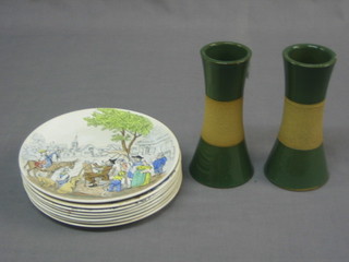 A pair of waisted pottery vases (some chips) 7" together with 8 French pottery plates decorated humerous scenes 8"