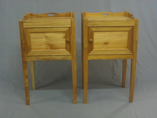 A pair of Georgian style bleached mahogany tray top bedside cabinets, each fitted a cupboard enclosed by panelled doors, raised on square tapering supports 17 1/2" 