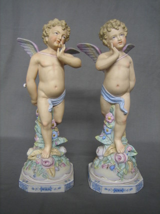 A pair of 19th Century biscuit porcelain figures of standing cherubs 15"