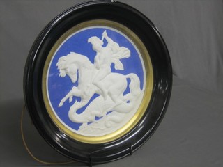 A circular plaster plaque depicting St George slaying the Dragon 13"