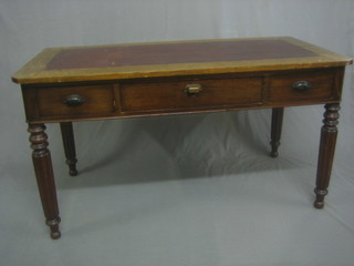A Victorian mahogany writing table fitted 1 long drawer flanked by 2 short drawers, raised on turned and reeded supports 51"