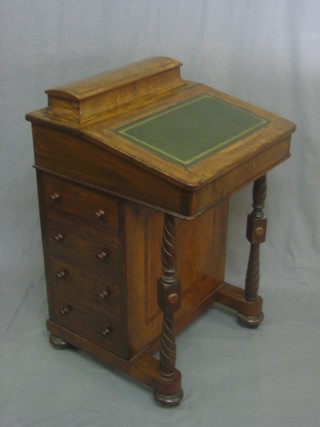 A Victorian walnut Davenport with hinged stationery box to the top, the pedestal fitted 4 drawers, raised on turned and block supports 21"