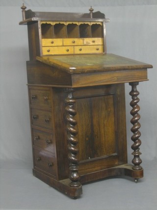A Victorian rosewood Davenport with three-quarter gallery having a side sliding top, the pedestal fitted 4 drawers, raised on spiral turned columns 24"