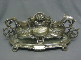 A large and impressive pierced metal twin handled centre piece raised on an oval twin handled tray