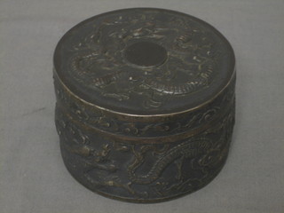 An Eastern cylindrical embossed silver jar and cover with dragon decoration 4 ozs