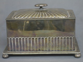 A rectangular silver plated biscuit box with demi reeded decoration and hinged lid, raised on bun feet by Hewkin & Heath 10"