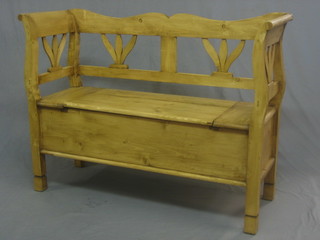 A Continental stripped and polished pine settle with hinged lid 47"