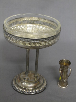 A circular pierced white metal table centre piece raised on 3 column supports together with a small silver vase