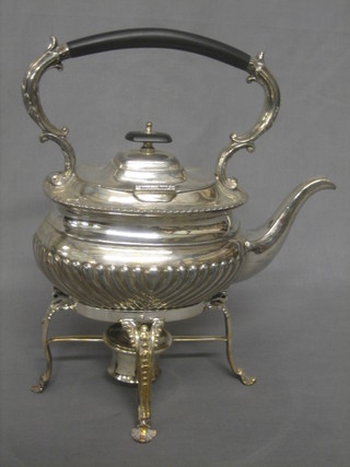 An oval Britannia metal spirit kettle raised on a stand complete with burner (no chains)
