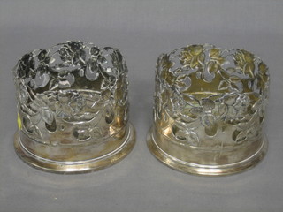 A pair of pierced white metal wine coasters, base marked Alpocca